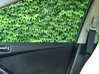 Jerking in car while woman walks by