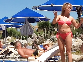 Nice Milf on the beach in orange bikini